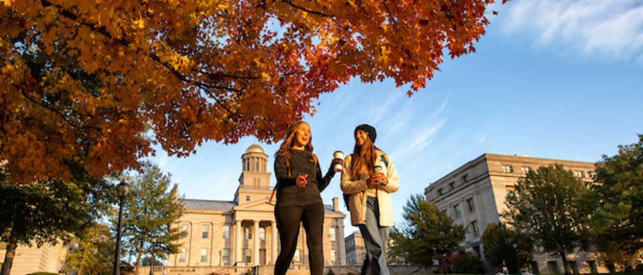 Two Students Walking on Campus in the Fall. 