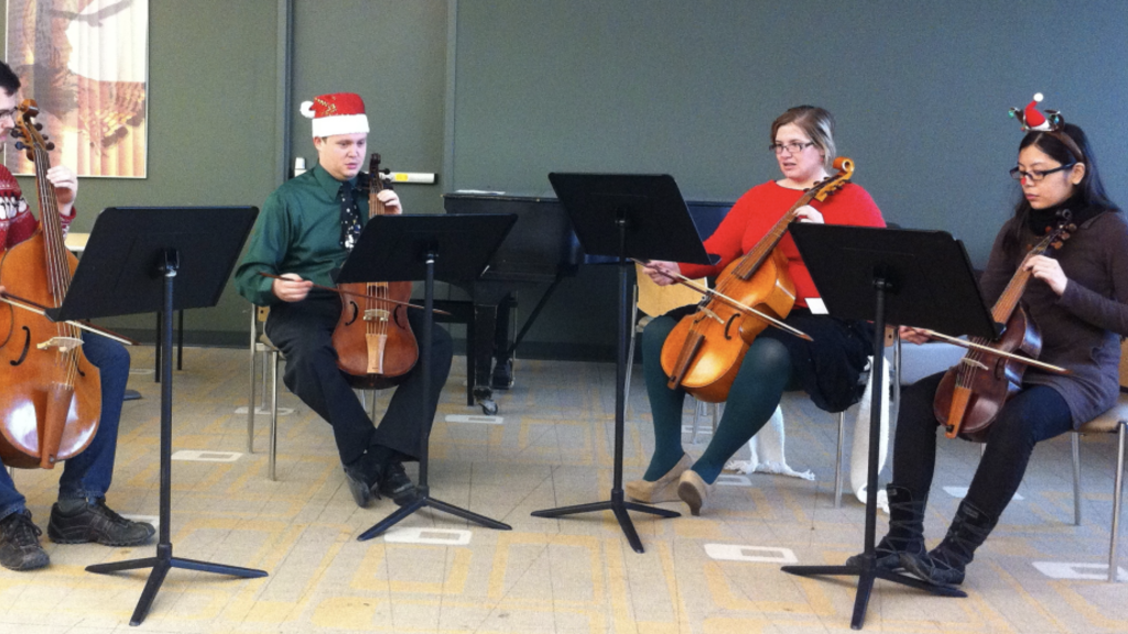 Image of Musicology Students playing historical string instruments. 