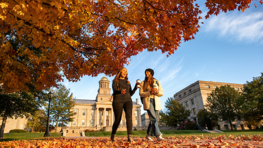 Two Students Walking on Campus in the Fall. 